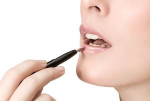 woman aplying lipstick