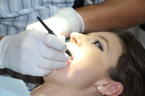 an orthodontist treating a patient